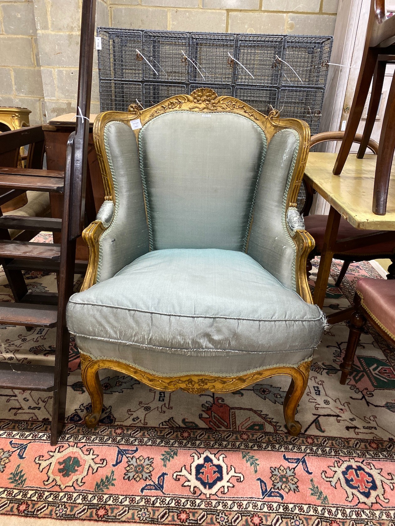 A Louis XV style carved giltwood fauteuil, width 70cm, depth 70cm, height 102cm